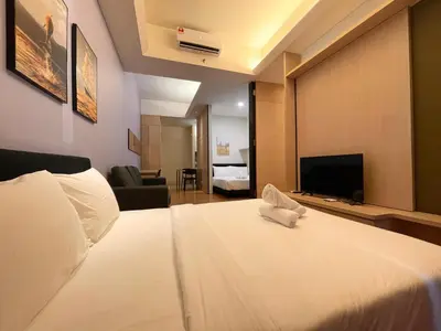 a hotel room with a bed and a television at Swiss Garden Residence by PILLOWTALKS in Kuala Lumpur