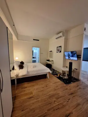 a bedroom with a bed and a flat screen tv at Times Square Service Apartment , Kuala Lumpur in Kuala Lumpur