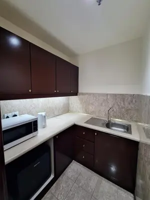 a kitchen with a sink and a microwave at Times Square Service Apartment , Kuala Lumpur in Kuala Lumpur