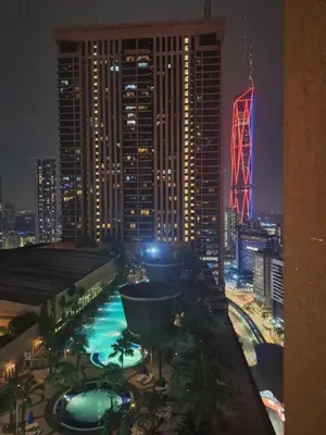 a view of a city skyline at night at Times Square Service Apartment , Kuala Lumpur in Kuala Lumpur