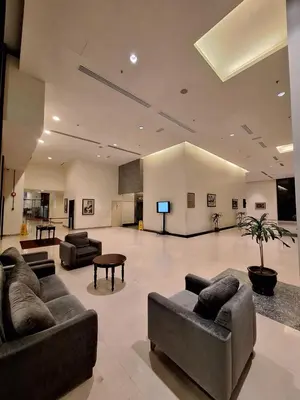 a large living room with couches and a flat screen tv at Midtown Suite At Times Square Hotel KL in Kuala Lumpur