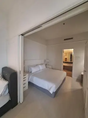 a bedroom with a large white bed and a window at Midtown Suite At Times Square Hotel KL in Kuala Lumpur