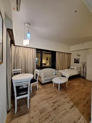 a living room with white furniture and a table at Midtown Suite At Times Square Hotel KL in Kuala Lumpur