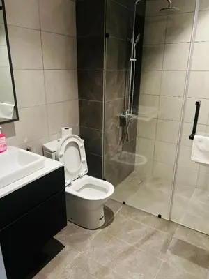 a bathroom with a shower and a toilet and a sink at Axon suites bukit bintang Klcc by Aura in Kuala Lumpur