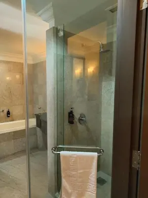 a bathroom with a glass shower with a towel at Visitor Suites At Times Square Kuala Lumpur in Kuala Lumpur