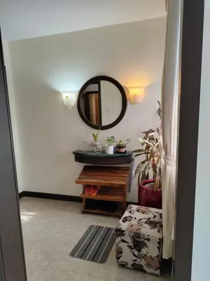 a hallway with a mirror and a wooden table at Visitor Suites At Times Square Kuala Lumpur in Kuala Lumpur