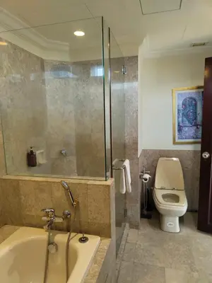 a bathroom with a shower and a tub and a toilet at Visitor Suites At Times Square Kuala Lumpur in Kuala Lumpur