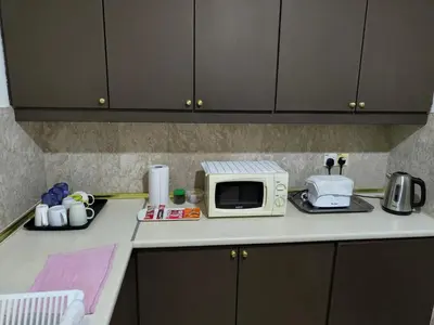 a kitchen counter with a microwave and appliances on it at BBS Suites At Times Square in Kuala Lumpur