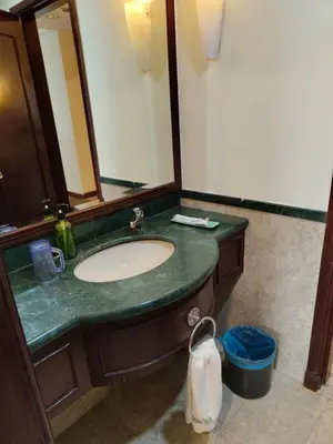 a bathroom with a sink and a mirror at BBS Suites At Times Square in Kuala Lumpur