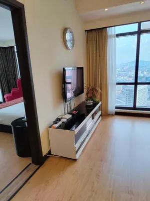 a hotel room with a bed and a television at BBS Suites At Times Square in Kuala Lumpur