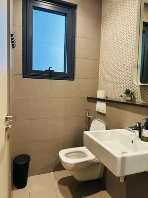 a bathroom with a toilet and a sink and a window at Lucentia Infinity Pool Suit Kuala Lumpur in Kuala Lumpur