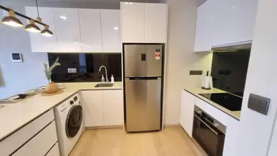 a kitchen with a stainless steel refrigerator and a dishwasher at Star Residences One klcc in Kuala Lumpur