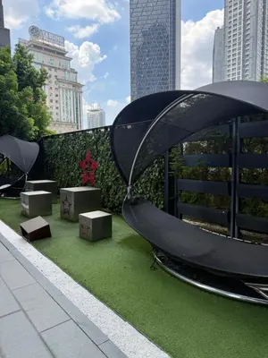a slide on the side of a building with green grass at Star Residences One klcc in Kuala Lumpur
