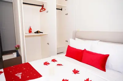 a bedroom with a white bed with red pillows at Agile Kuala Lumpur City Centre By AMG in Kuala Lumpur