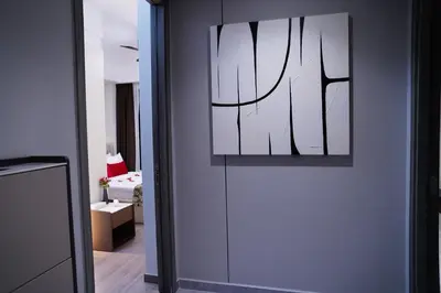 a room with a door with a painting on the wall at Agile Kuala Lumpur City Centre By AMG in Kuala Lumpur