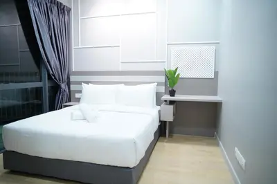 a bedroom with a white bed and a desk at Luxury Apartment - DATUM JELATEK - KLCC- LRT - MDMT - MALL - PARKING in Kampong Datok Keramat