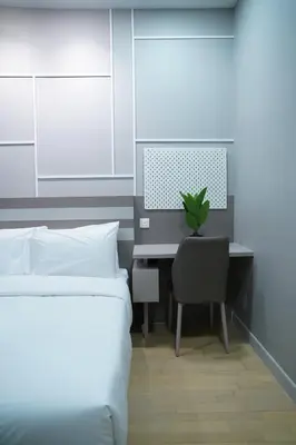 a bedroom with two beds and a desk with a computer at Luxury Apartment - DATUM JELATEK - KLCC- LRT - MDMT - MALL - PARKING in Kampong Datok Keramat