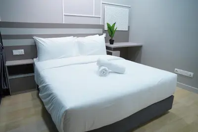 a large white bed in a bedroom with a plant on it at Luxury Apartment - DATUM JELATEK - KLCC- LRT - MDMT - MALL - PARKING in Kampong Datok Keramat
