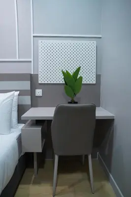 a desk with a chair and a plant on it at Luxury Apartment - DATUM JELATEK - KLCC- LRT - MDMT - MALL - PARKING in Kampong Datok Keramat