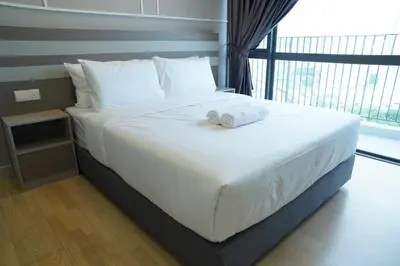 a large white bed with two towels on it at Luxury Apartment - DATUM JELATEK - KLCC- LRT - MDMT - MALL - PARKING in Kampong Datok Keramat