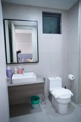 a bathroom with a sink and a toilet and a mirror at Luxury Apartment - DATUM JELATEK - KLCC- LRT - MDMT - MALL - PARKING in Kampong Datok Keramat