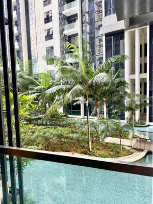 a view from the balcony of a building with palm trees at Garden Balcony 2BR Home with Great Facilities and Parking in Kuala Lumpur