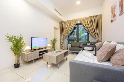 a living room with a couch and a tv at Garden Balcony 2BR Home with Great Facilities and Parking in Kuala Lumpur