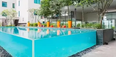 a swimming pool in front of a building at Summer Suites KLCC in Kuala Lumpur