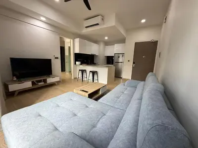 a living room with a large bed and a kitchen at STAR Suites Residence KLCC in Kuala Lumpur