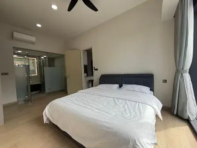 a bedroom with a large bed with white sheets at STAR Suites Residence KLCC in Kuala Lumpur