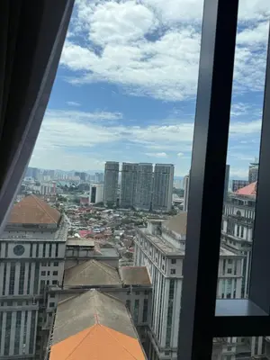 a view of a city from a window at Star Residences One KLCC in Kuala Lumpur