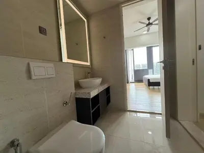 a bathroom with a toilet and a sink and a mirror at Star Residences One KLCC in Kuala Lumpur