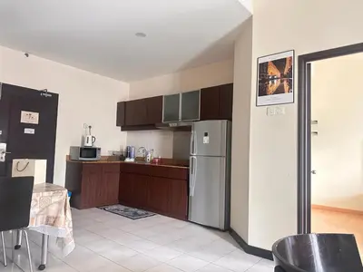 a kitchen with a stainless steel refrigerator and cabinets at Bukit bintang central seri Bukit Ceylon in Kuala Lumpur