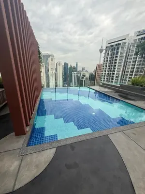 a swimming pool on the roof of a building at Majestic Residence KLCC Sky view in Kuala Lumpur