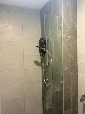 a shower stall with a phone in a bathroom at Majestic Residence KLCC Sky view in Kuala Lumpur