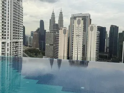 a swimming pool with a view of a city skyline at Majestic Residence KLCC Sky view in Kuala Lumpur