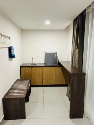 a room with a desk with a sink and a bench at Elite Hotel KL Sentral in Kuala Lumpur