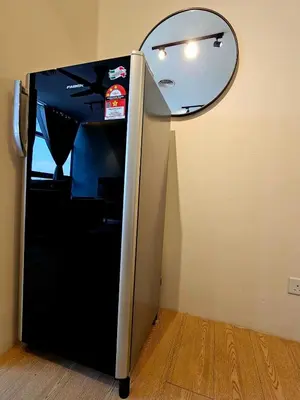 a black refrigerator in a room with a mirror at Metro Studio - Direct LRT access, near Pantai Hospital, University Malaya, Mid Valley, Bangsar in Kuala Lumpur
