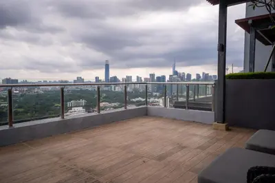 a balcony with a view of a city skyline at 2PAX-4PAX Projector Screen Stay near KLCC & Jelatek LRT Station in Kuala Lumpur