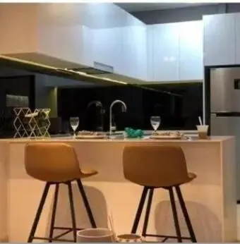 a kitchen with two chairs and a counter with a sink at Star Residences One klcc in Kuala Lumpur