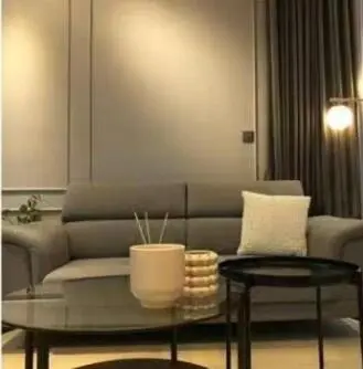 a living room with a couch and two tables at Star Residences One klcc in Kuala Lumpur