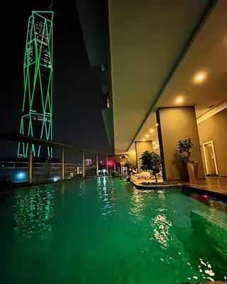 a pool of green water in a building at night at Casa Residency Apartment Bukit Bintang by Cupid home in Kuala Lumpur