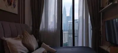 a hotel room with a bed and a large window at Sky Touch Homestay in Kuala Lumpur