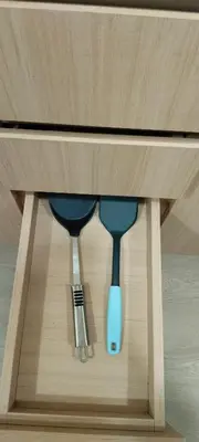 two measuring spoons sitting inside of a cabinet at Sky Touch Homestay in Kuala Lumpur