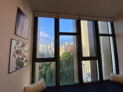 a room with a window with a view of a city at Ceylonz suites Klcc by StayLa in Kuala Lumpur