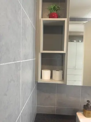 a bathroom with two rolls of toilet paper in a cabinet at Robertson Residence in Kuala Lumpur in Kuala Lumpur