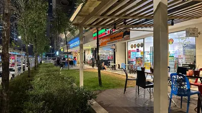 a group of shops on a city street at night at Balcony Cityscape V The Robertson Residence 36f in Kuala Lumpur