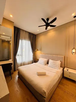 a bedroom with a bed with a ceiling fan at Lucentia residence by lalaport in Kuala Lumpur
