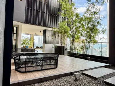 a house with a balcony with tables and trees at Lucentia residence by lalaport in Kuala Lumpur