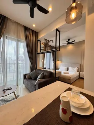 a living room with a couch and a table at Lucentia residence by lalaport in Kuala Lumpur